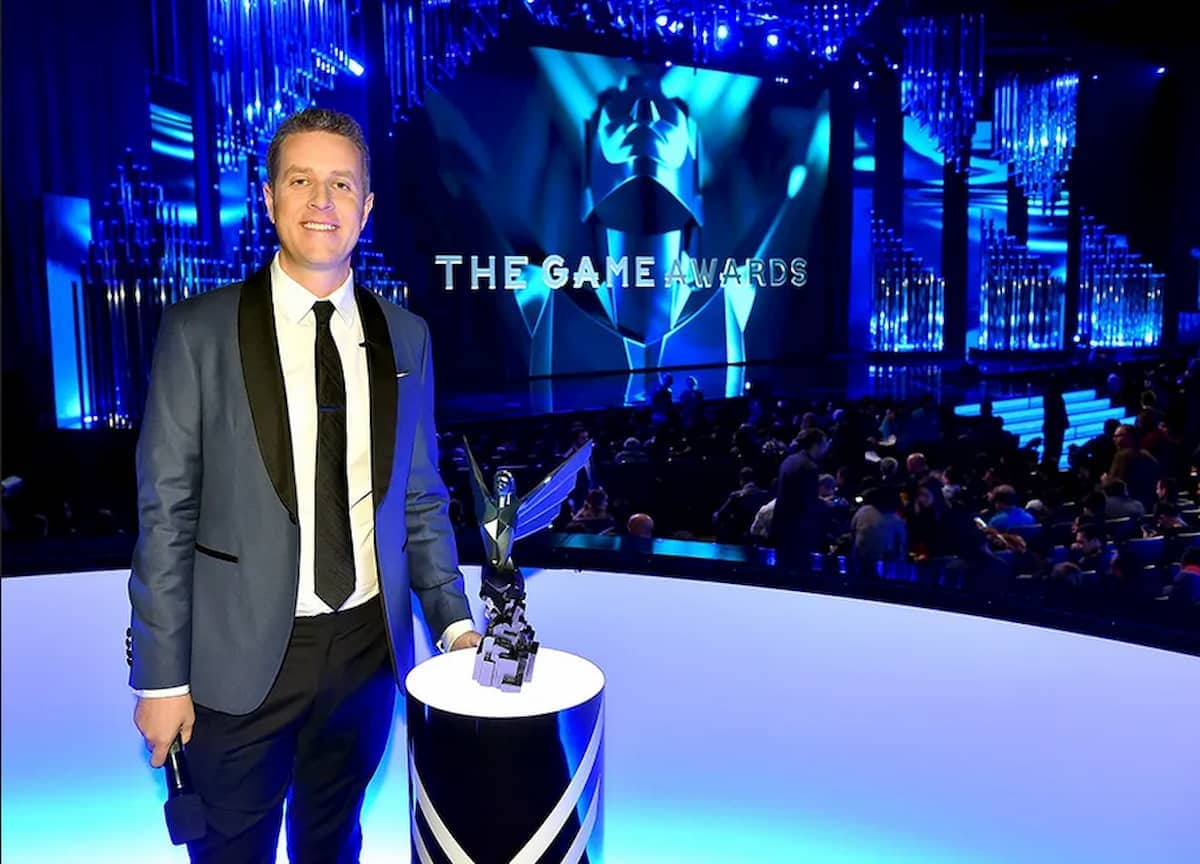 Presenter of the Game Awards with a game award trophy.